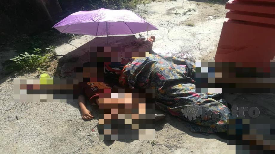 Anak wanita Rohingya berada di sisi mayatnya selepas maut ditikam suaminya di Kampung Gong Garu, Gaal di Pasir Putih pagi hari ini. Foto Ihsan Pembaca 