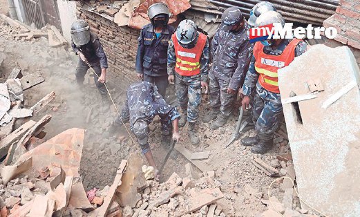 SEPASUKAN tentera membersihkan runtuhan untuk mencari mangsa di Bhaktapur. 