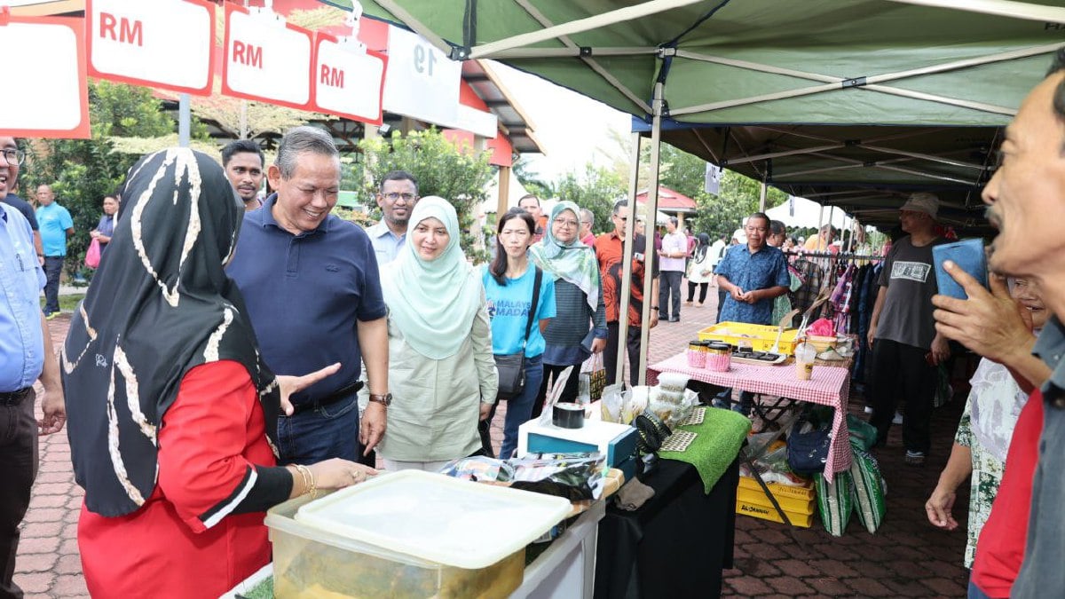 Aminuddin (dua dari kiri) meninjau produk jualan agro madani di Kampung Pachitan hari ini. Foto Ihsan Pejabat MB