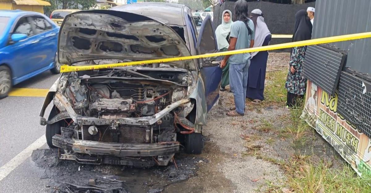 Kereta yang dipandu seorang guru, Noraini Ismail, 55, terbakar di jalan Kampung Pak Tuyu, di sini berhampiran Universiti Sultan Zainal Abidin (UniSZA), pagi tadi. Foto FAIZUL AZLAN RAZAK