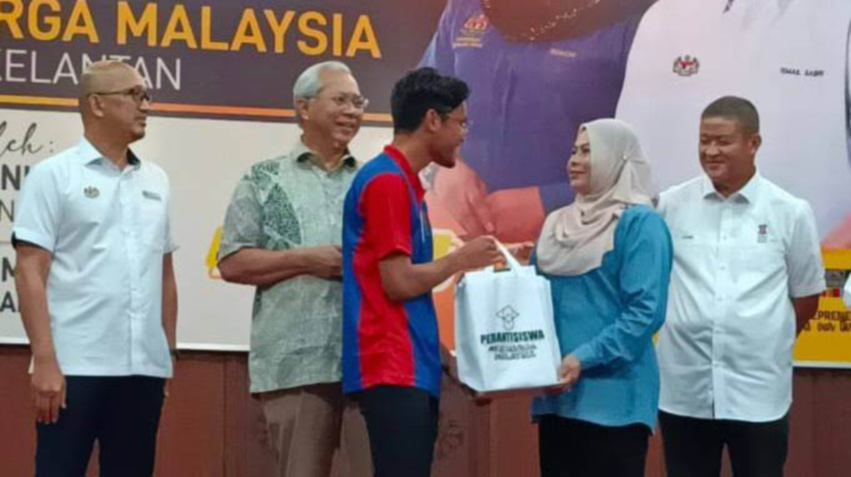 Dr Noraini (dua dari kanan) menyampaikan peranti kepada salah seorang penuntut  ketika di Universiti Malaysia Kelantan (UMK) Kampus Kota, di sini, hari ini. FOTO IHSAN UMK