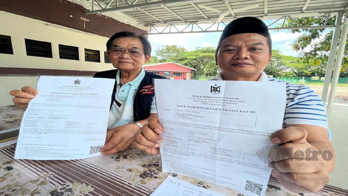 Norizal (kanan) bersama Francis menunjukkan notis kadar senarai nilaian baharu yang diterima daripada MPKj. FOTO Ekhwan Haque Fazlul Haque