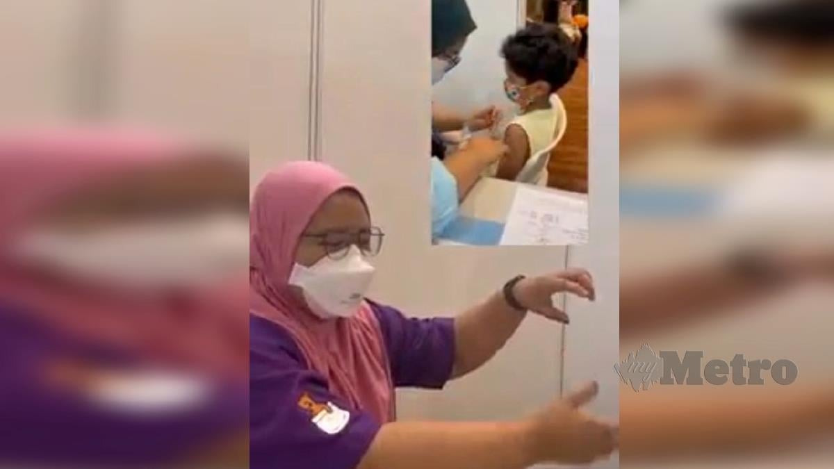 TANGKAP layar dari video mengenai jururawat yang memberikan vaksin kepada anak bongsu Khairy. FOTO Ihsan FB KKM