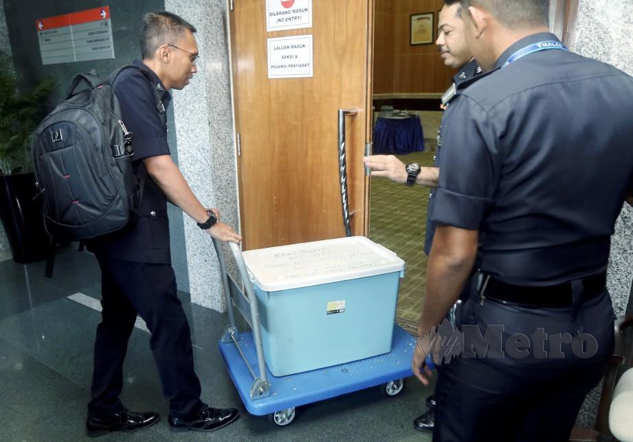 Bukti dan kertas siasatan dibawa masuk ke bilik prosiding ketika sesi pendengaran awam RCI hari ini. FOTO Mohd Fadli Hamzah
