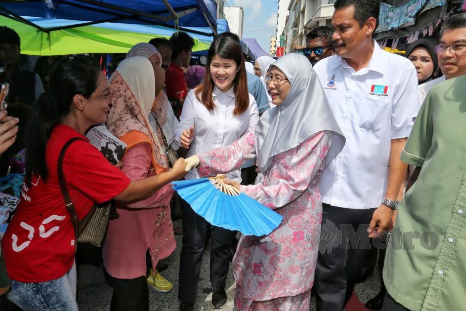 DR Wan Azizah (dua kanan) bersama Wong (tiga kanan) bertemu pengunjung dan peniaga di Pasar Tamu Sandakan. FOTO Khairull Azry Bidin