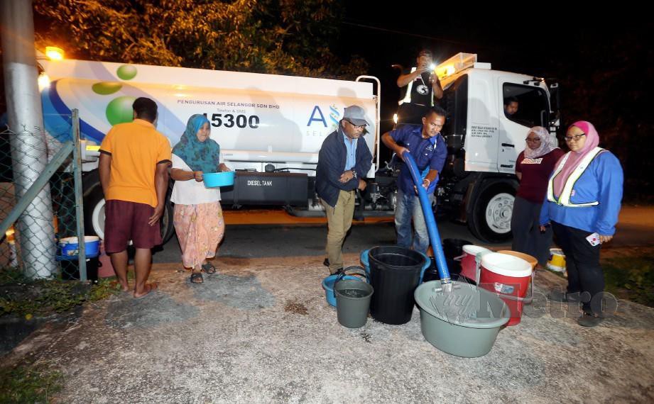 Penduduk menerima bekalan air bersih dari lori tangki berikutan beberapa kawasan di Melaka terjejas bekalan air. FOTO Rasul Azli Samad