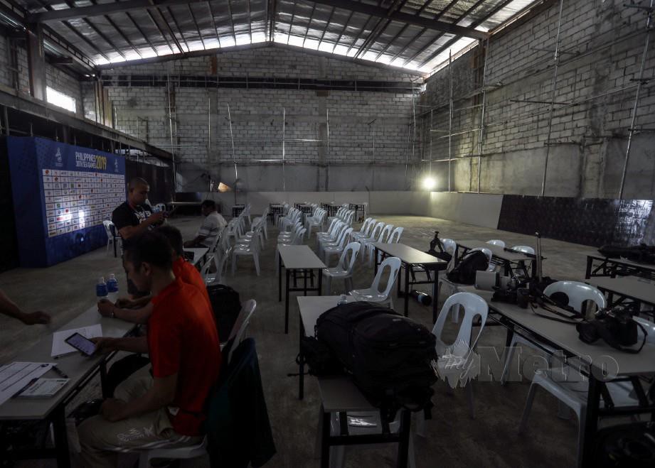 KEADAAN pusat sidang media serta bilik media serba tidak lengkap sepenuhnya 30 minit sebelum bemulanya perlawanan bola sepak Kumpulan A pertama di Stadium Memorial Rizal. FOTO Osman Adnan