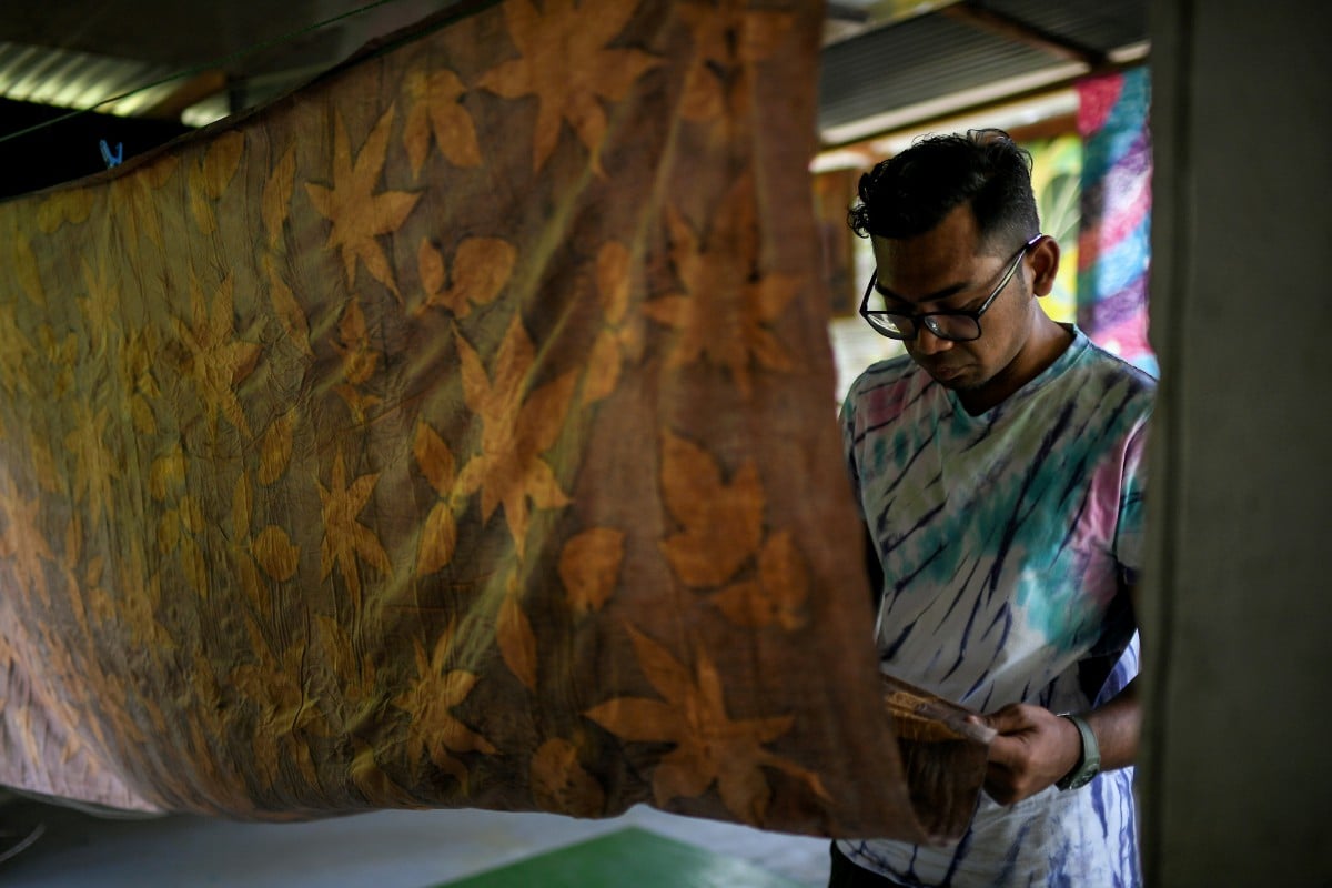 Khairizal meneliti hasil seni kraf batik yang menggunakan teknik 'Ecoprint.' FOTO Bernama