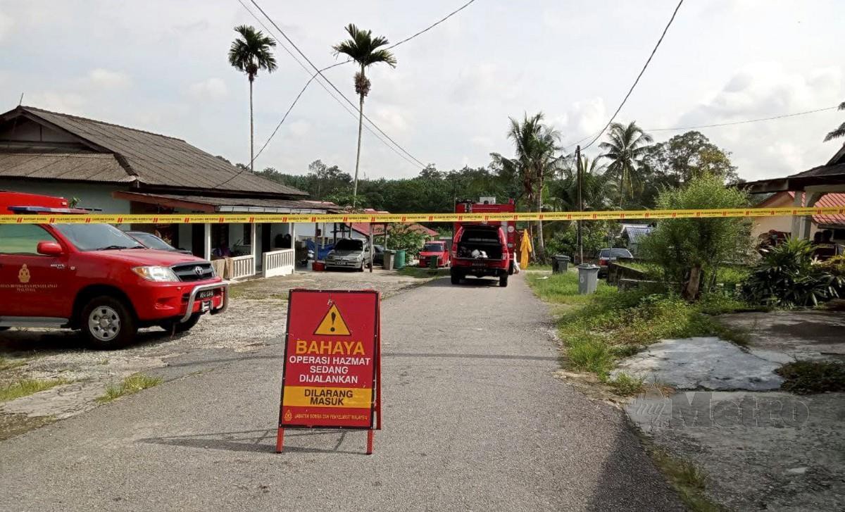 PASUKAN HAZMAT Jabatan Bomba dan Penyelamat Malaysia (JBPM) memasang papan tanda larangan masuk di kawasan berdekatan pencemaran kimia di Kampung Baru Maju Sri Aman. FOTO Omar Ahmad