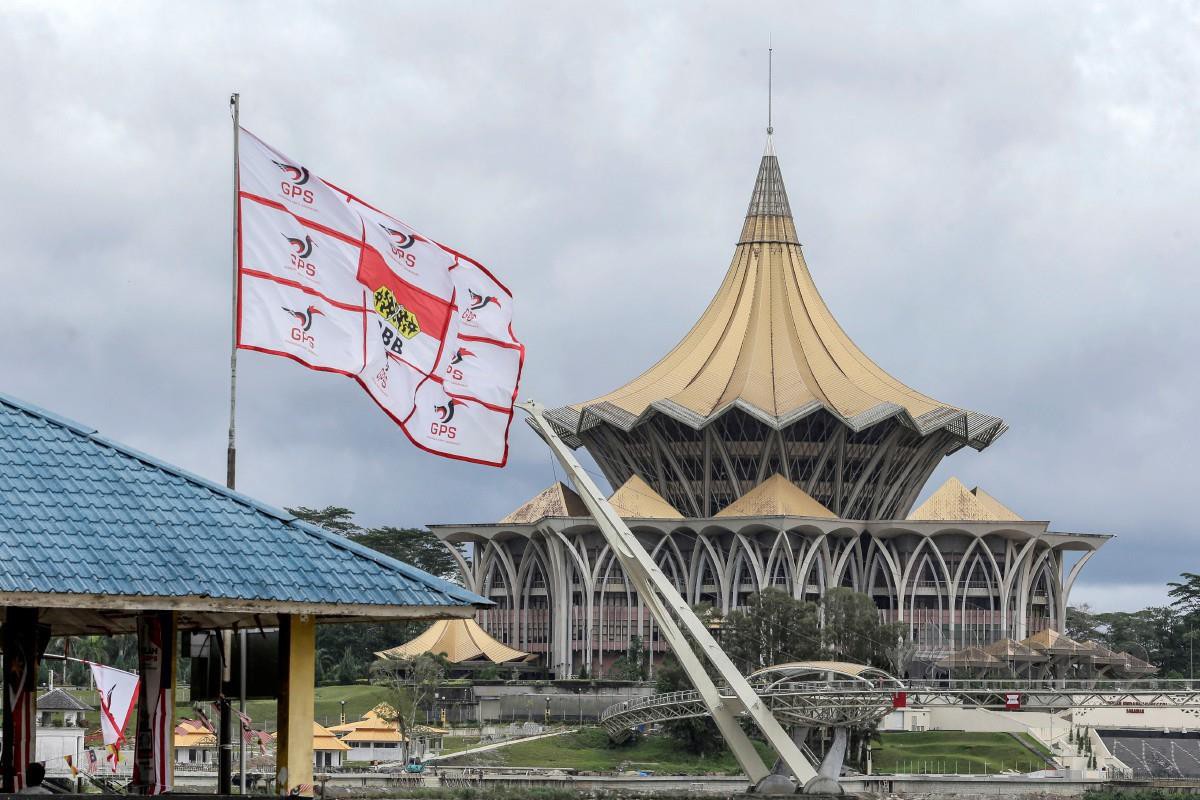 KIBARAN bendera parti GPS bersama Parti Pesaka Bumiputera Bersatu (PBB) di pengkalan perahu penambang Kampung Lintang berlatar belakang bangunan Dewan Undangan Negeri (DUN) Sarawak ketika tinjauan sempena PRN Sarawak, kelmarin. FOTO Aizuddin Saad