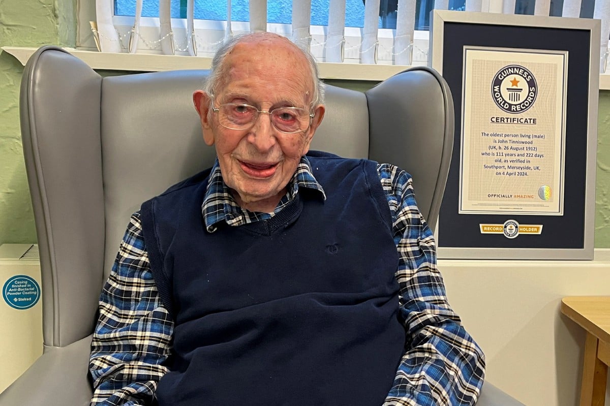 TINNISWOOD bersama sijil daripada Guinness World Records yang mengiktirafkannya sebagai lelaki tertua di dunia. FOTO Reuters