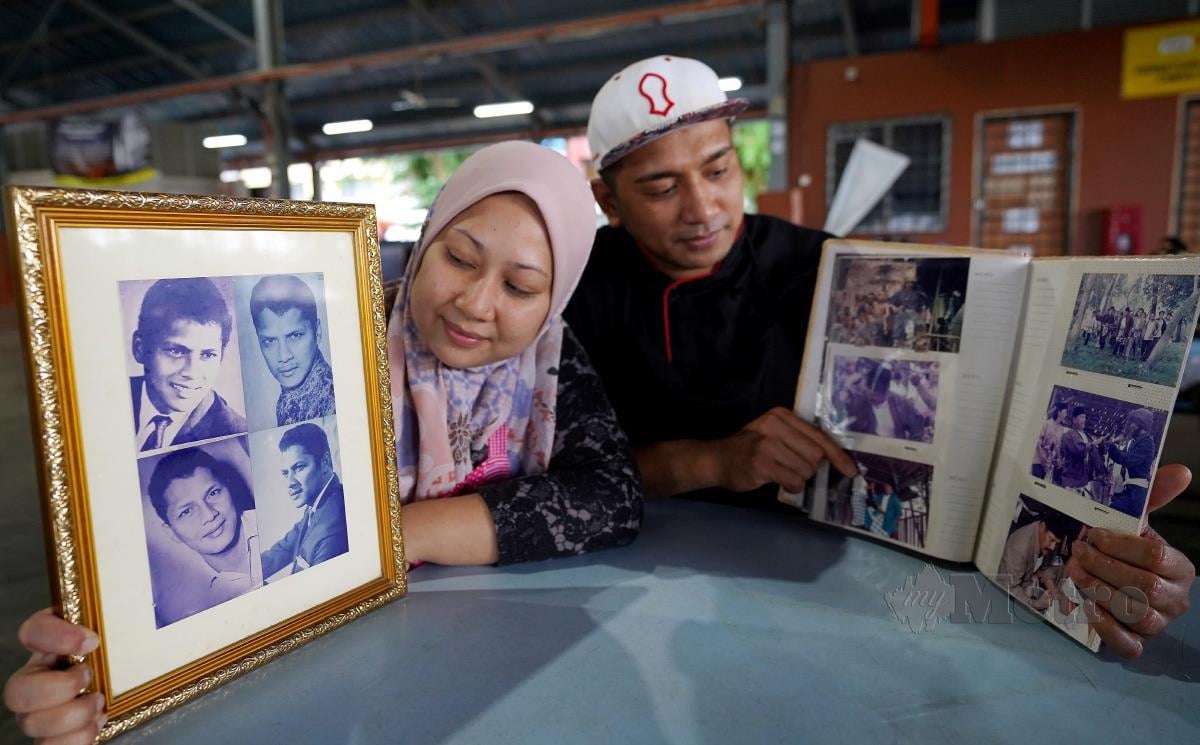 Jasmin (kiri) bersama suami menunjukkan album gambar arwah Kuswadinata. FOTO Effendy Rashid