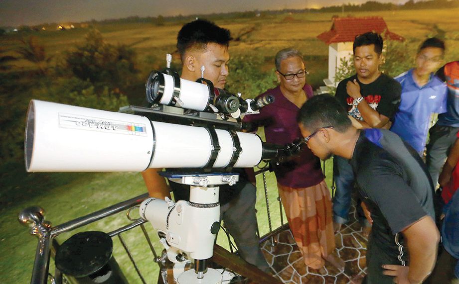 DR Mahamarowi (dua dari kiri) memberi tunjuk ajar untuk berkongsi ilmu dalam bidang astronomi dengan pelajar Sekolah Menengah Agama Mahaad Amir Indra Petra, Bachok di halaman rumahnya. 