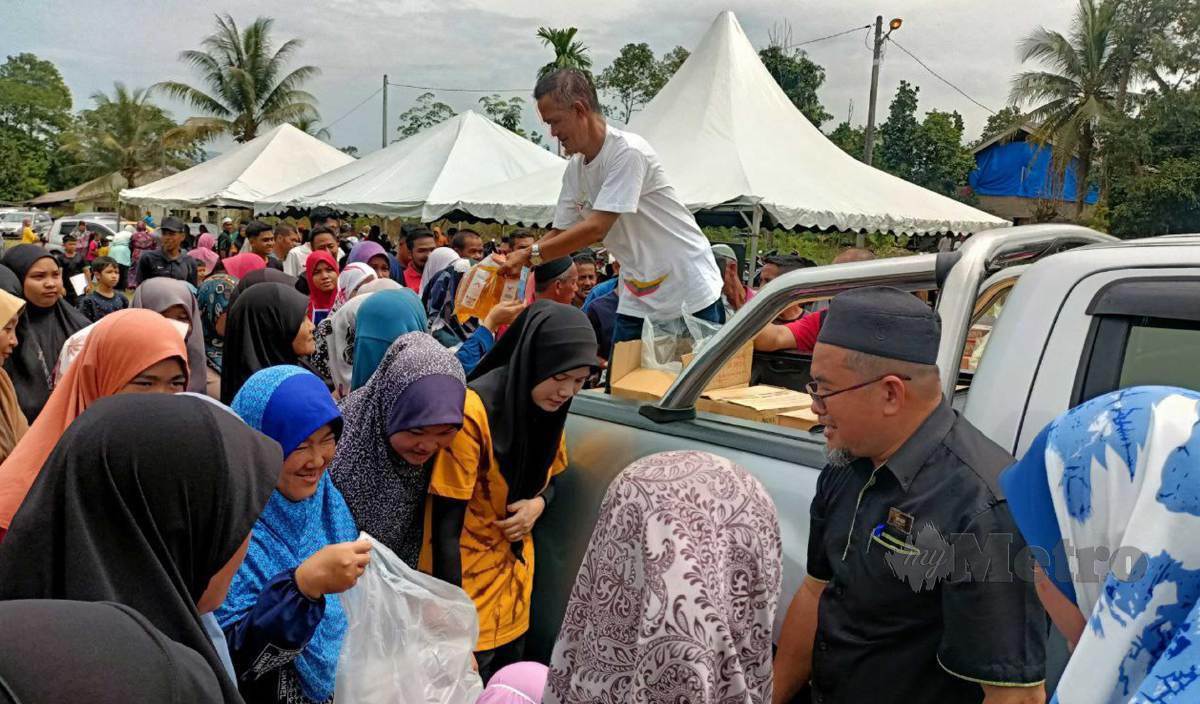 ORANG ramai berebut untuk membeli minyak masak paket yang dijual pada harga RM10 bagi empat paket dalam jualan borong di Kampung Bendang Besar. FOTO Siti Rohana Idris