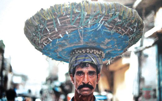 PEKERJA di Rawalpindi sudah biasa membawa barangan di atas kepala.