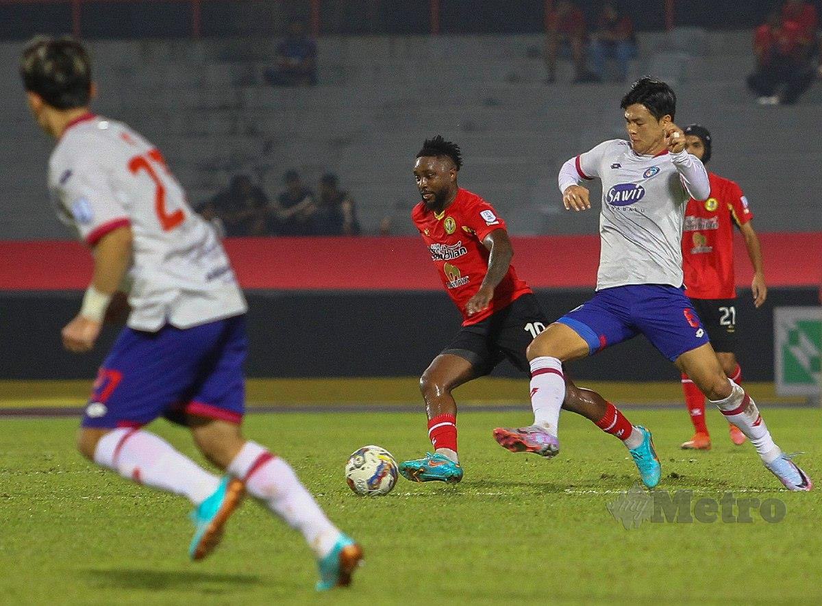 PEMAIN NSFC, Levy Madinda (tengah) diasak pemain Sabah, Park Taesu (kanan) pada perlawanan Stadium Tuanku Abdul Rahman, Paroi. FOTO AZRUL EDHAM