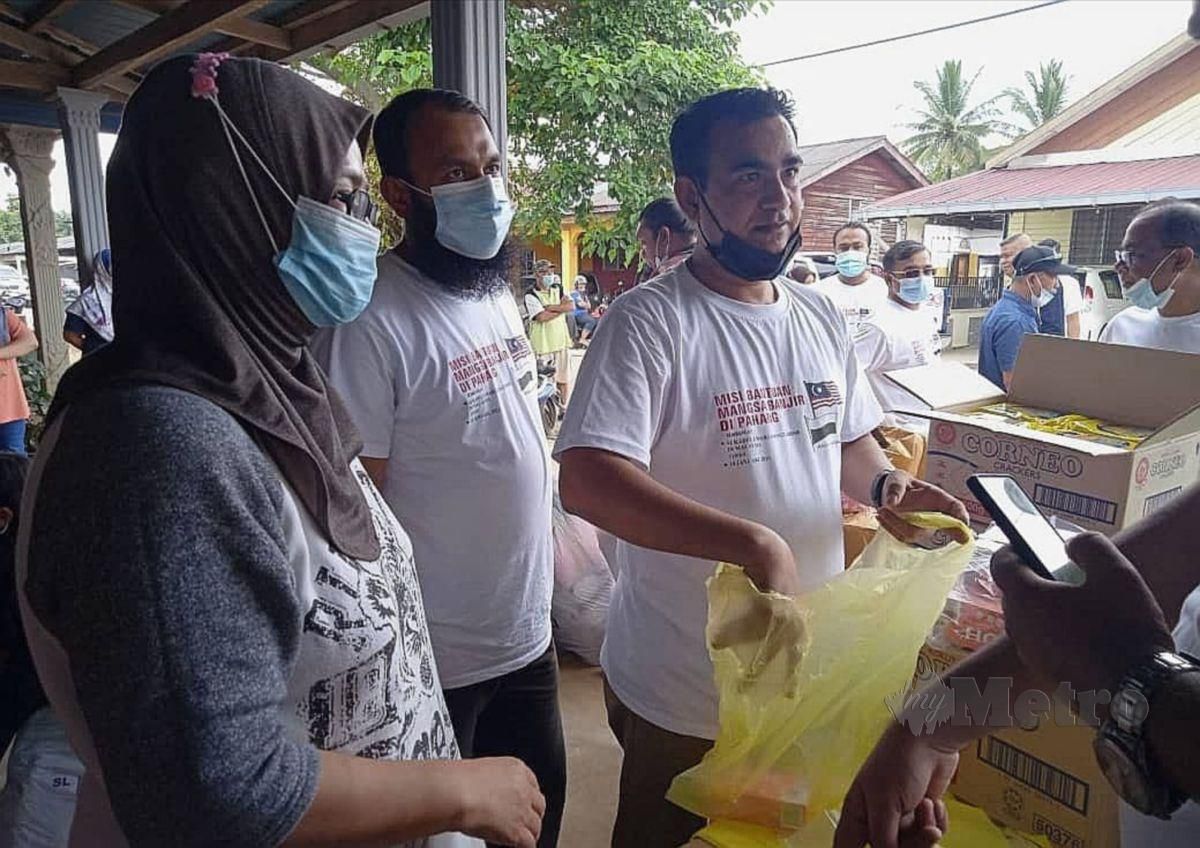 ZAKARIA (kanan) menyampaikan bantuan kepada  penduduk di Taman Desa Kuala Krau. FOTO Roselan Ab Malek