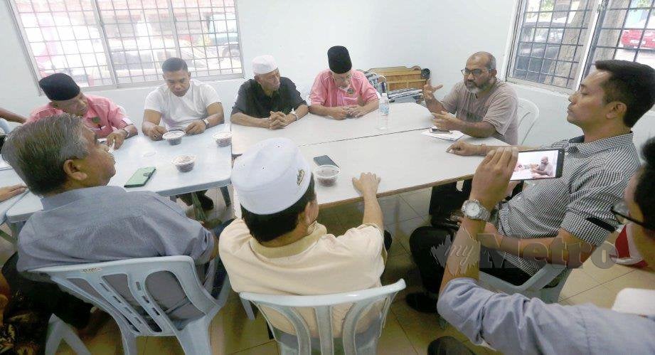 GULAM Muszaffar (dua kanan) bersama penduduk berbincang mengenai notis diterima daripada DBKL bagi mengambil alih pengurusan dewan di Dewan PKNS Jalan Kucing. FOTO Rosdan Wahid 