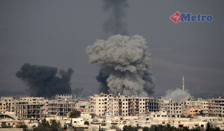 KEPULAN asap akibat serangan udara tentera kerajaan Syria di Hamouria, Ghouta Timur.  FOTO AFP
