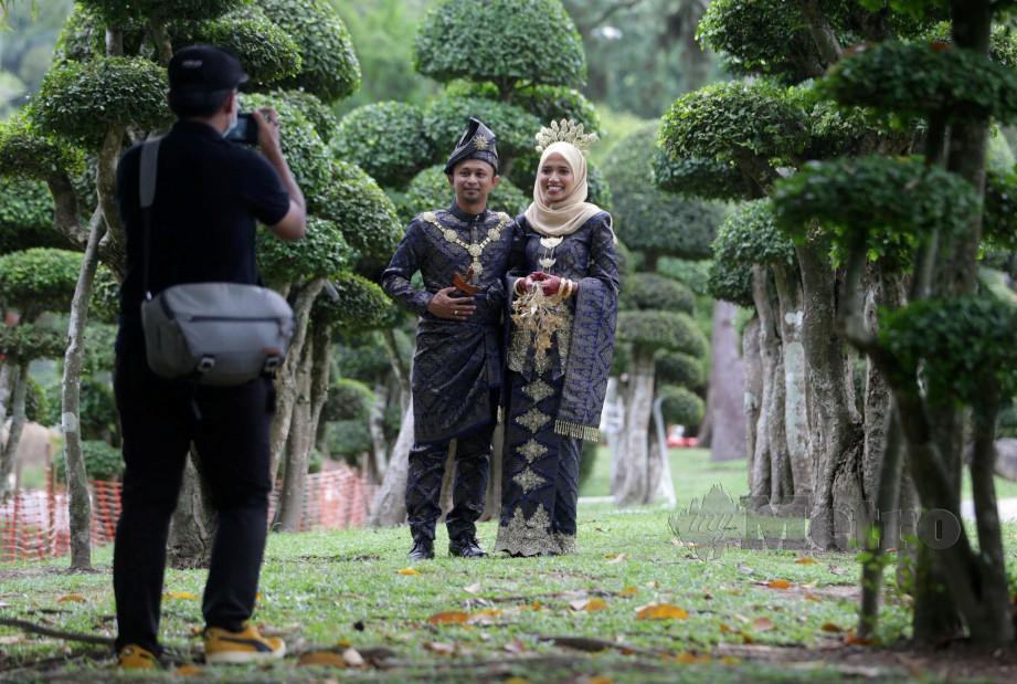 MOHD Khairul Amri dan pasangan memilih mengabdikan kenangan di Taman Botani Perdana. FOTO Mohamad Shahril Badri Saali.