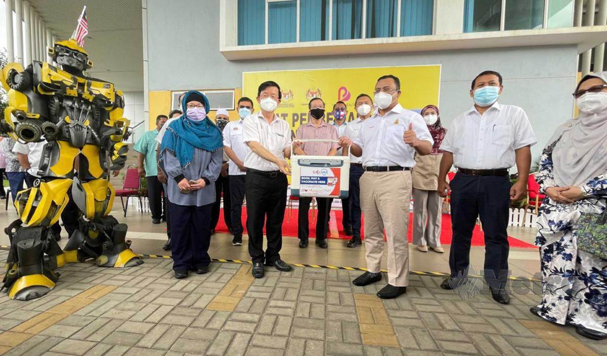 CHOW Kon Yeow (dua kiri) menerima sumbangan 20,000 dos vaksin Covid-19 daripada Amirudin dalam satu majlis ringkas di PPV SP Arena Seberang Jaya. FOTO Nur Izzati Mohamad