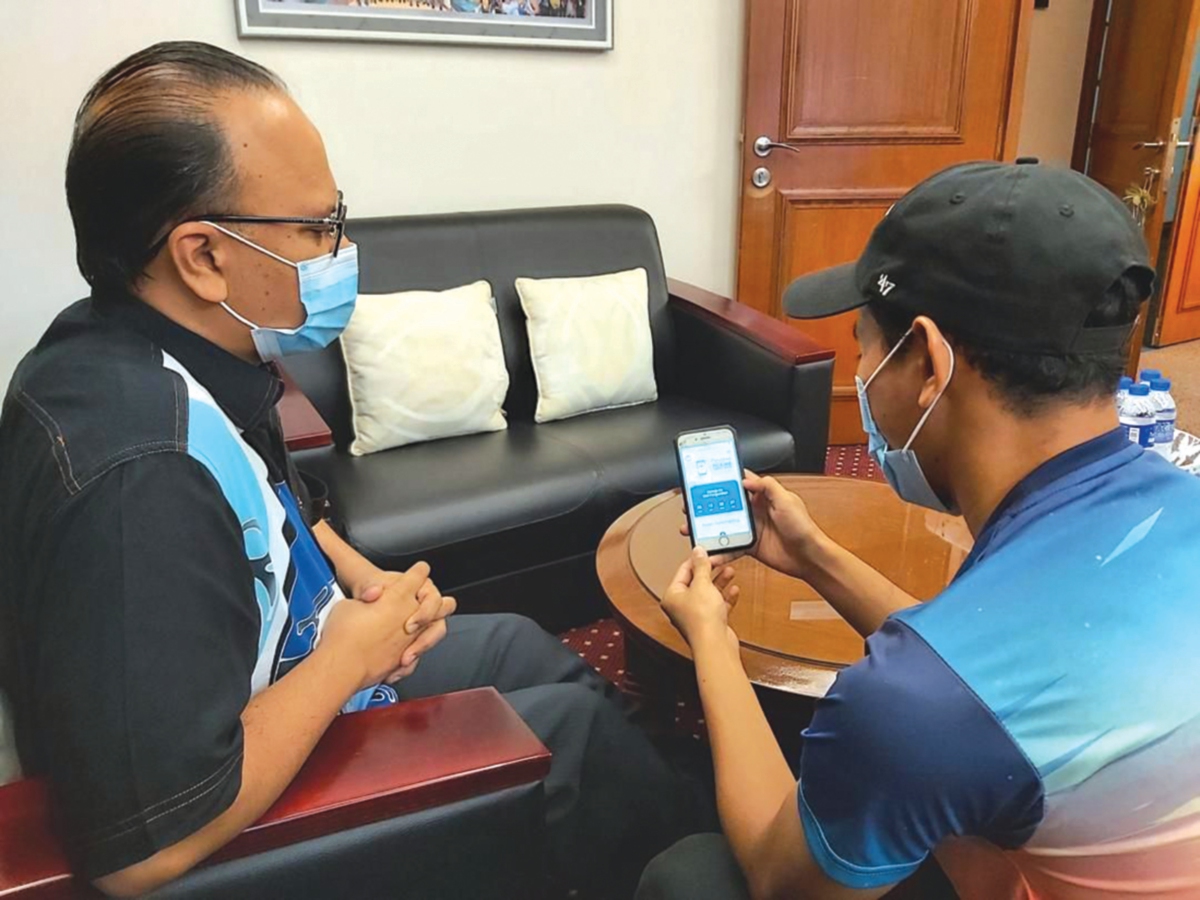 DR Mohd Rushdan (kiri) melihat portal khas yang dibangunkan untuk Pemilihan MPP USIM kali ini di telefon pintar. 