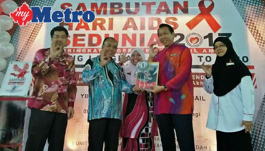 Norhizan (empat dari kiri) menyampaikan sijil kepada peserta yang hadir sempena Sambutan Hari Aids Sedunia Peringkat Negeri di Pusat Beli Belah Langkawi Fair, Langkawi, hari ini. Foto Hamzah Osman