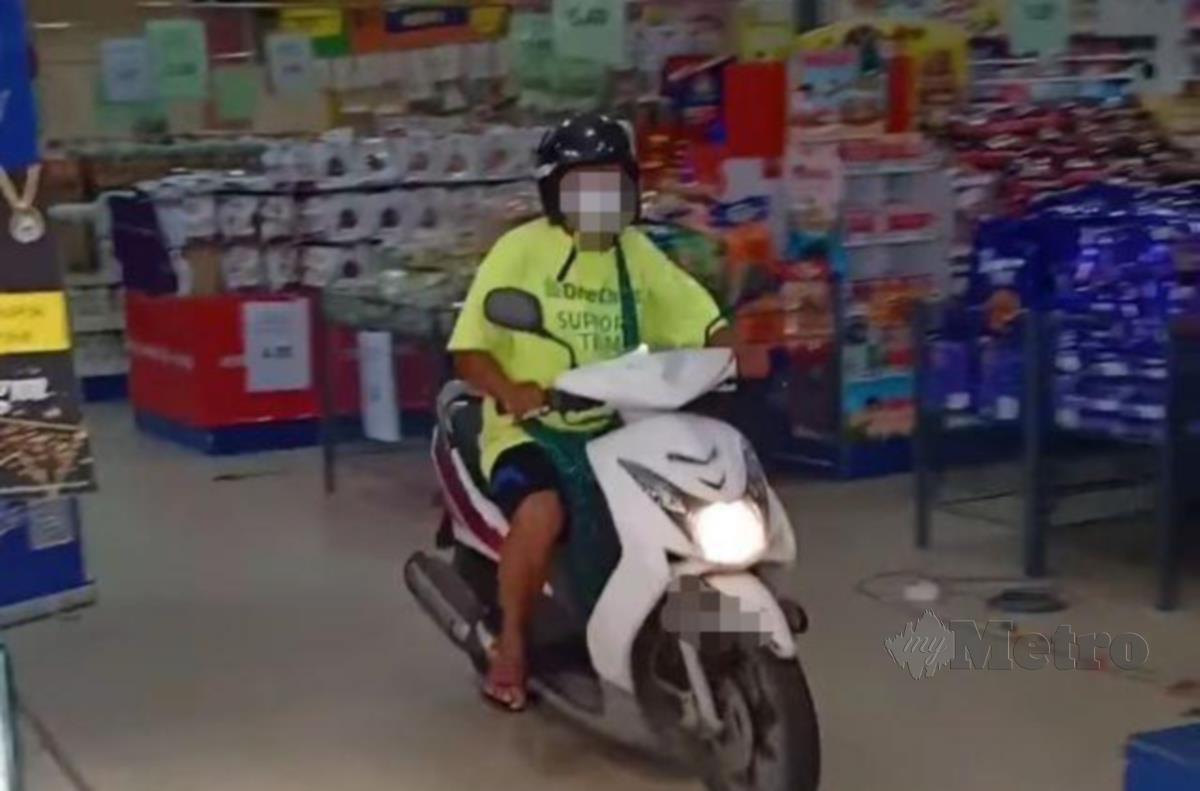 Lelaki yang menunggang motosikal di dalam sebuah pasar raya, tular di media sosial sejak semalam. FOTO /IHSAN PEMBACA 