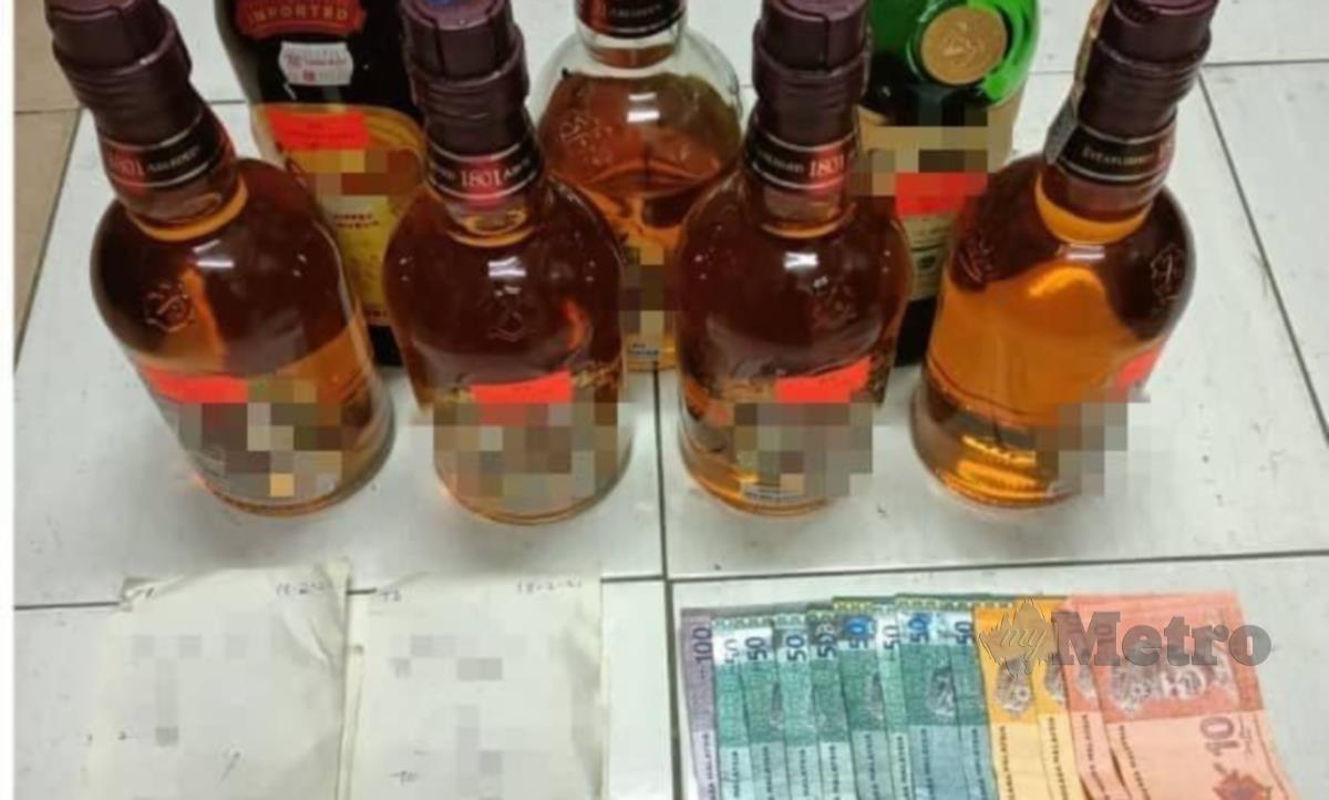 ANTARA minuman keras serta wang tunai yang dirampas dalam serbuan itu. FOTO IHSAN PDRM