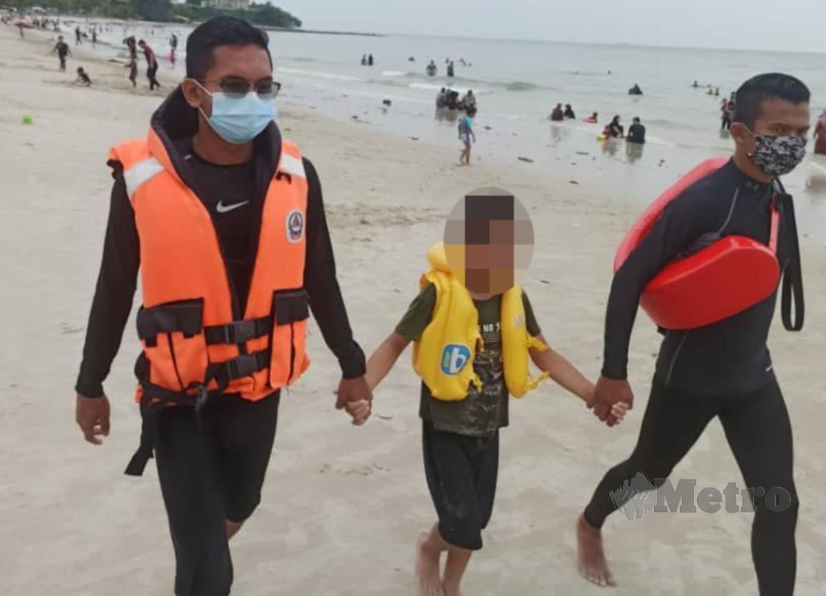 Anggota APM mencari keluarga kepada kanak-kanak yang terpisah daripada keluarganya ketika beriadah di Pantai Teluk Kemang, di sini, Ahad lalu. FOTO IHSAN APM
