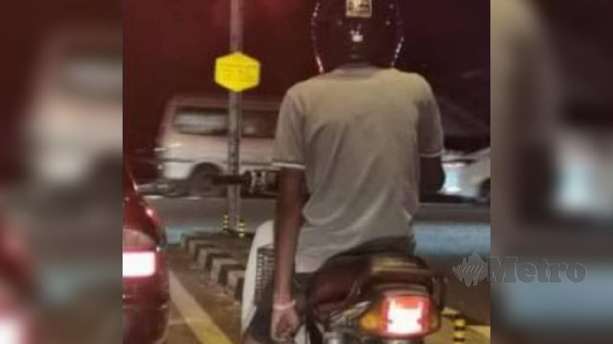 Gambar daripada video yang tular mengenai seorang lelaki memakai gelang kuarantin menunggang motosikal di sekitar Padang Serai dekat Kulim. Foto Ihsan PDRM