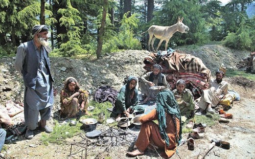 SEKUMPULAN anggota etnik Bakarwal berhenti untuk makan di lebuh raya Jammu-Srinagar.