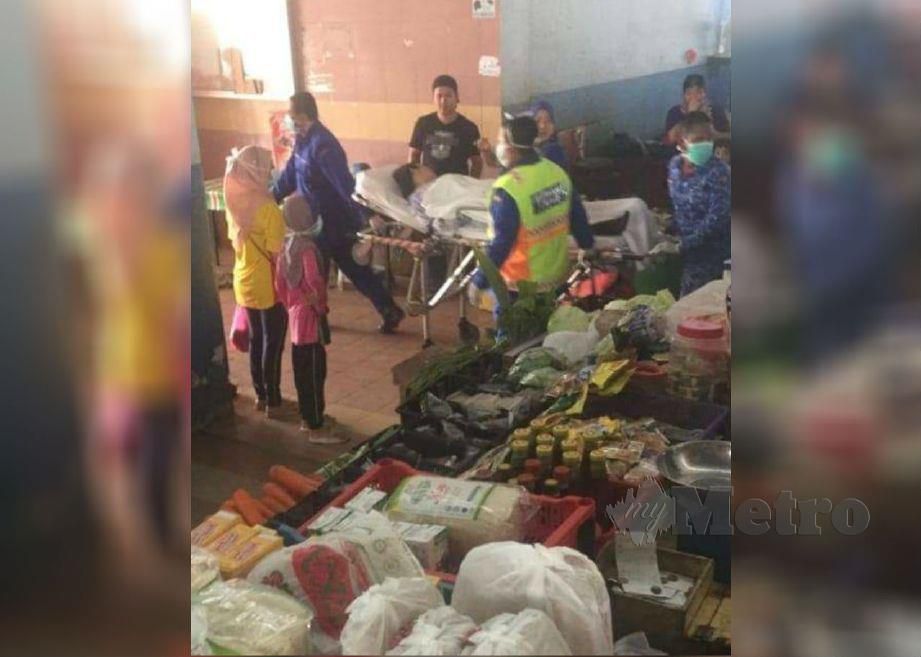 WANITA yang pengsan diberi bantuan oleh anggota perubatan di Pasar Awam Sungai Besar, Selangor