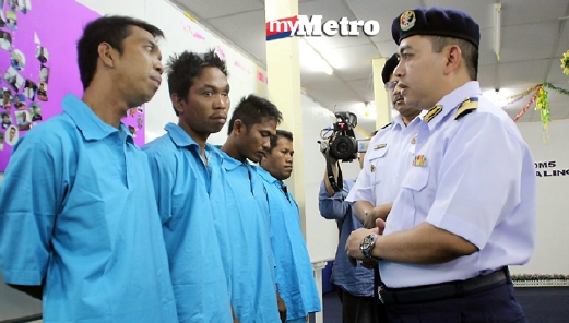 Ketua Penguatkuasa APMM Daerah Maritim 5, Kuala Linggi, Kapten Maritim Mazlan Mat Rejab menyoal empat lelaki Indonesia yang ditahan. - Foto MUHAMAD ZUHARI ZUBIR