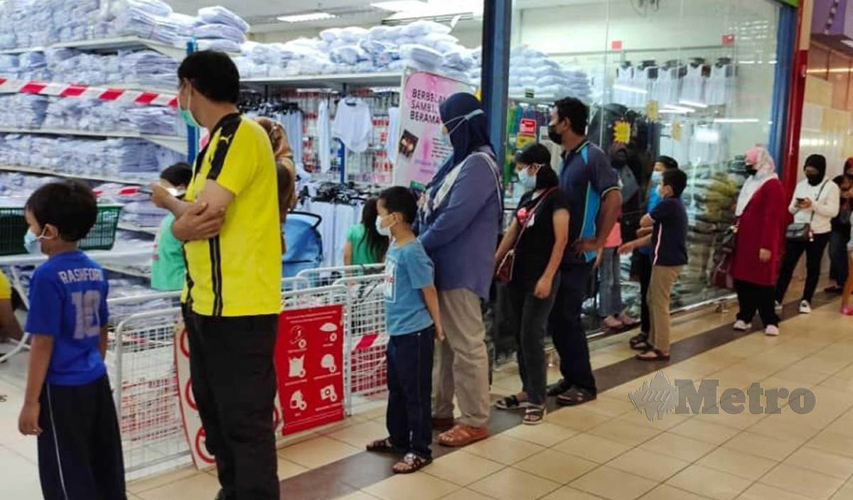 IBU BAPA membuat persiapan awal membeli pakaian sekolah anak-anak di pasaraya di Kempas. FOTO Omar Ahmad