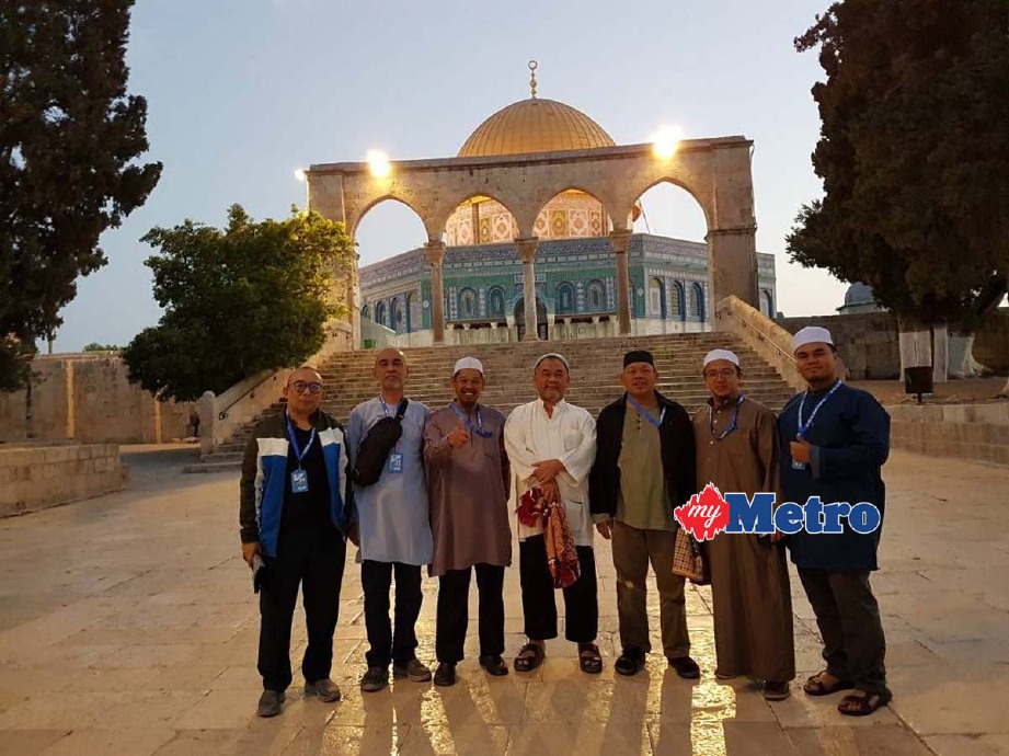 Abd Rahman (kiri) bersama rakan jemaah bergambar dalam kawasan Masjidil al-Aqsa selepas menunaikan solat Subuh di luar masjid itu, hari ini. - Foto Ihsan YAYASAN AL AMIN