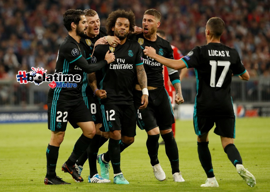 PEMAIN Real Madrid, Marcelo (tengah) meraikan jaringan bersama rakan sepasukan ketika aksi separuh akhir pertama Liga Juara-Juara menentang Bayern Munich. - Foto AFP