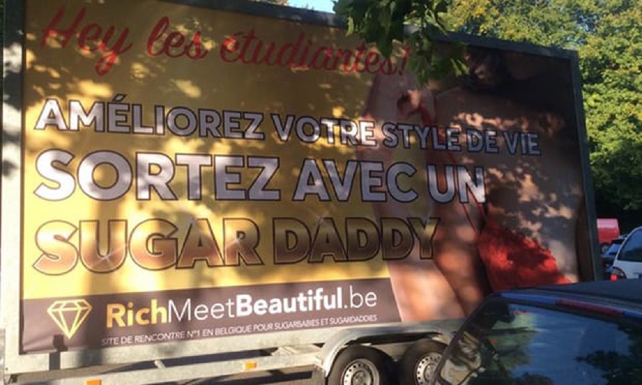 Lori membawa iklan mempromosikan ‘sugar daddy’ kepada pelajar Belgium yang diletak di depan sebuah universiti di Brussels, semalam. - Foto The Guardian