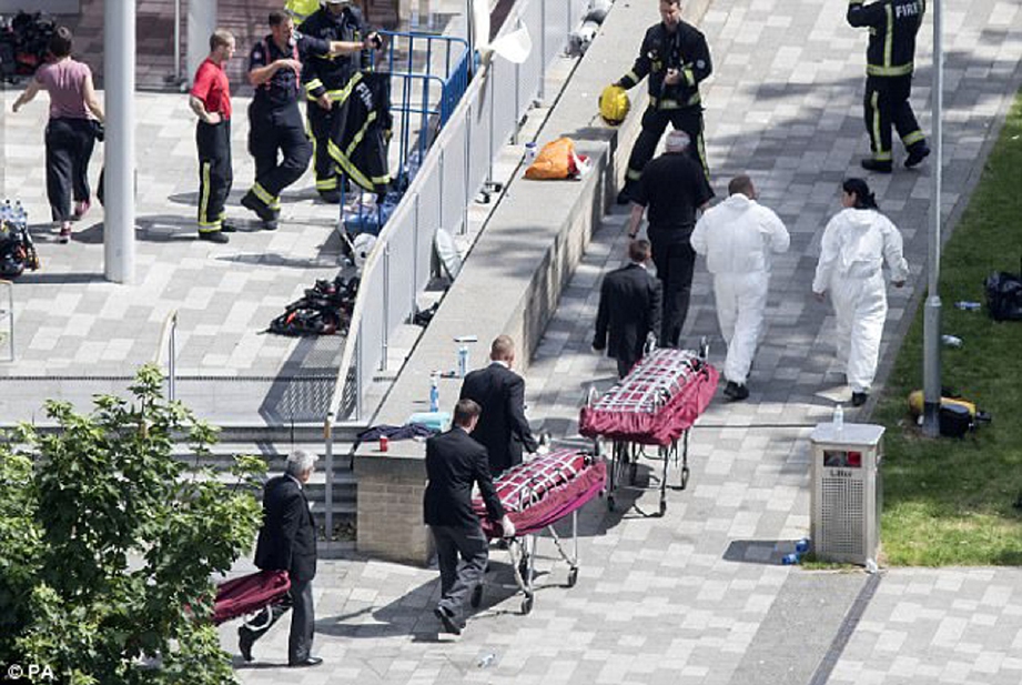 Pasukan paramedik membawa mayat mangsa ke hospital. - Foto Daily Mail