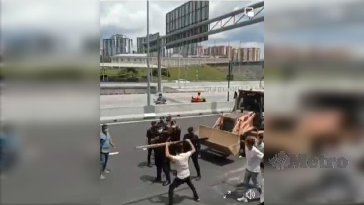 TANGKAP layar video menunjukkan sekumpulan individu bersenjatakan besi dan kayu menyerang anggota polis yang tular di media sosial, hari ini. FOTO Ihsan Pembaca