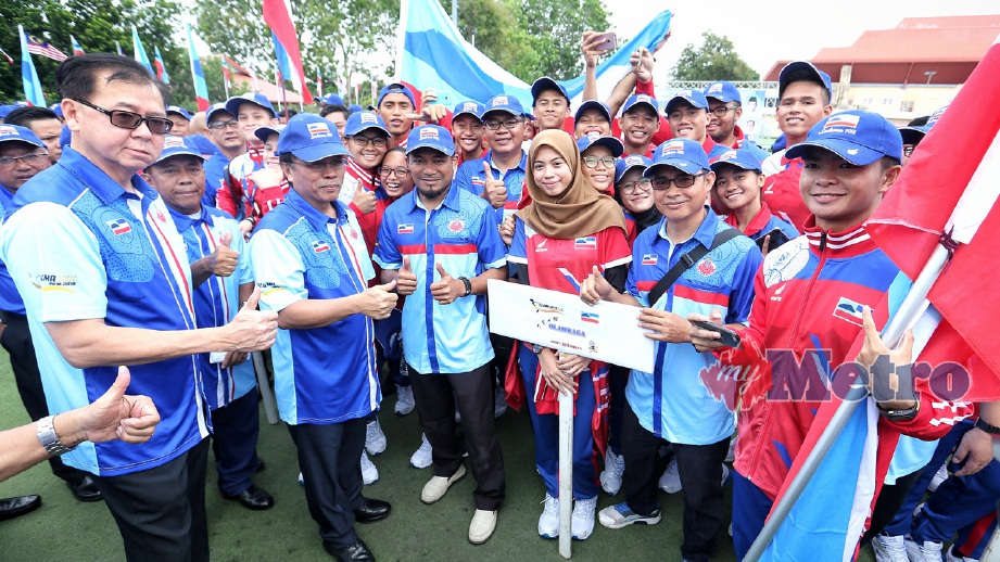 Shafie (tiga dari kiri) bersama atlet pada majlis penyerahkan bendera kontinjen Sabah. FOTO KHAIRULL AZRY BIDIN.
