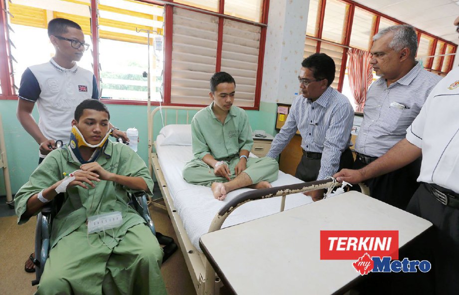 A Latiff  (dua kanan) dan Shafruddin Ali (kanan) melawat pelajar yang dibuli, Ahmad Zikrill (berkerusi roda) dan Wan Ahmad Faris (atas katil) yang masih dirawat di Hospital Sultanah NurZahirah. FOTO ROZAINAH ZAKARIA