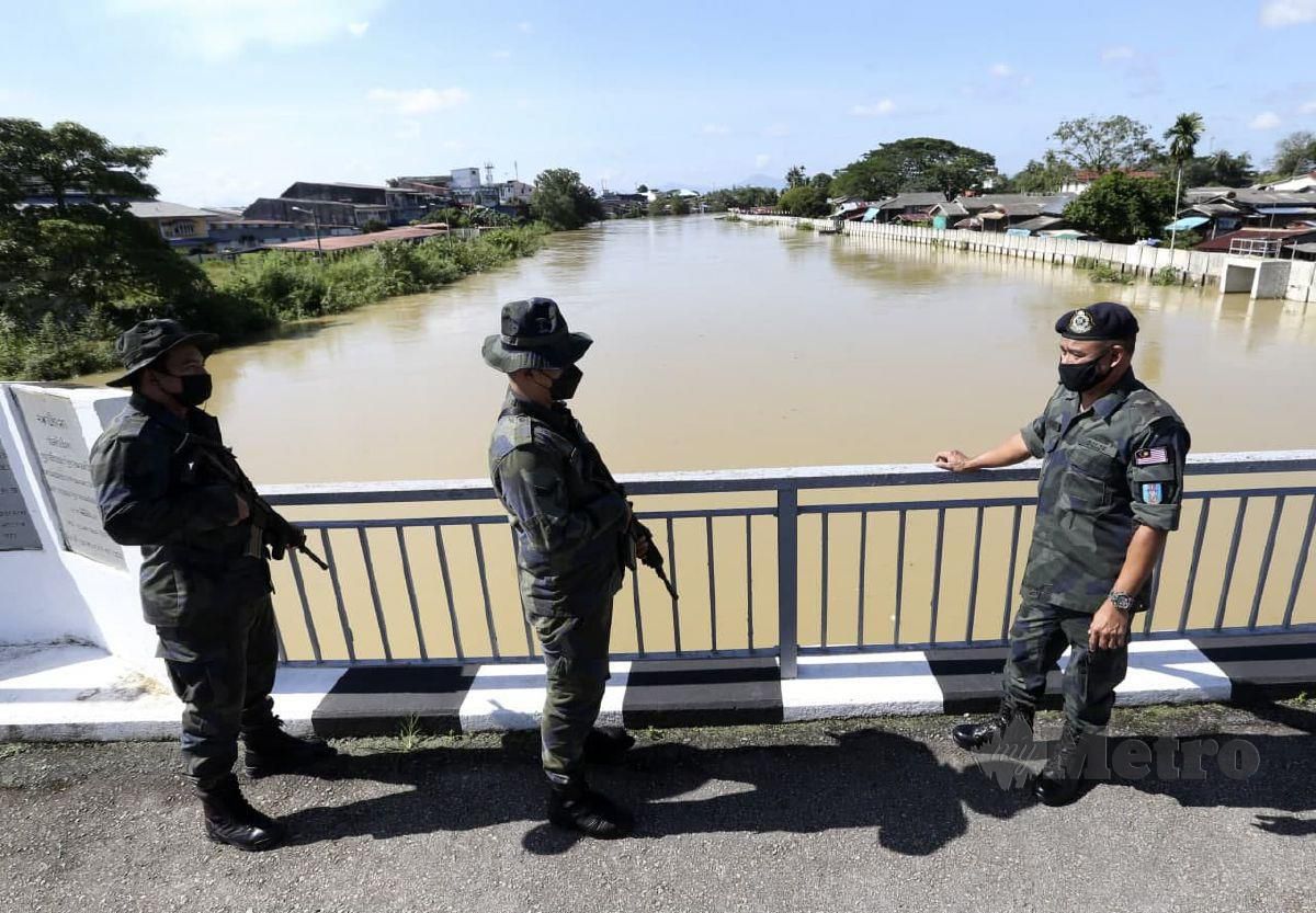 AZHARI Nusi bersama anggotanya membuat tinjauan air sungai golok di atas Jambatan Muhibah untuk ke negara Thailang di Rantau Panjang. FOTO NIK ABDULLAH NIK OMAR