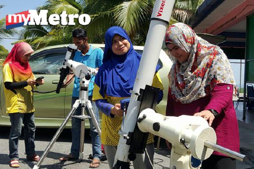 Kakitangan ONL memasang teleskop sebagai pesediaan untuk aktiviti mencerap gerhana matahari separa di pekarangan Sekolah Kebangsaan Sungai Menghulu, Langkawi, hari ini. FOTO Hamzah Osman