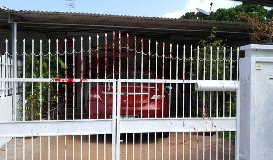 KEADAAN pagar rumah dan kereta yang disimbah cat merah. FOTO Ihsan Susan Loone