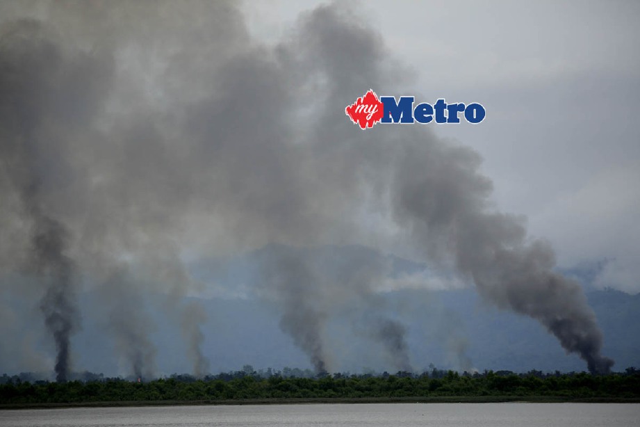 Kepulan asap dari perkampungan Rohingya di Tamrobill di sempadan Myanmar dekat Teknaf, Bangladesh, yang dibakar tentera Myanmar, hari ini. - Foto  EPA