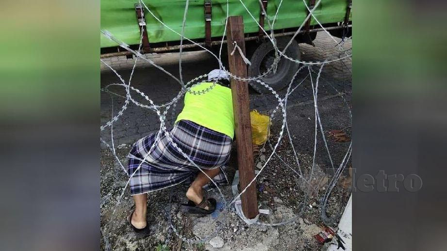 LELAKI warga Myanmar ditahan ketika cuba meloloskan diri melalui pagar kawat duri di Jalan 9/3A berhampiran Pasar Borong Kuala Lumpur. FOTO ihsan pembaca