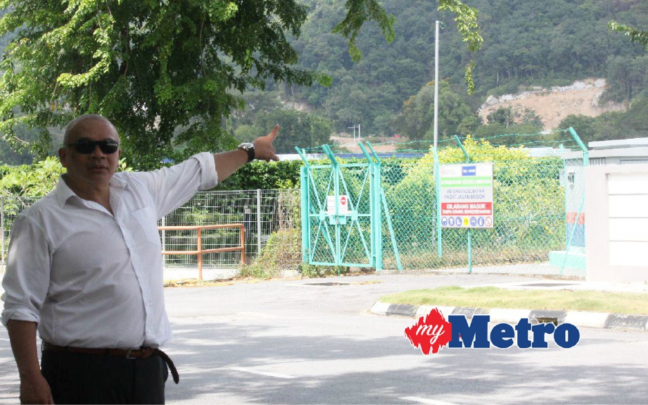 Yan Lee menunjukkan kesan aktiviti pembangunan cerun bukit berhampiran Jalan Batu Gantung. FOTO Zuhainy Zulkiffli