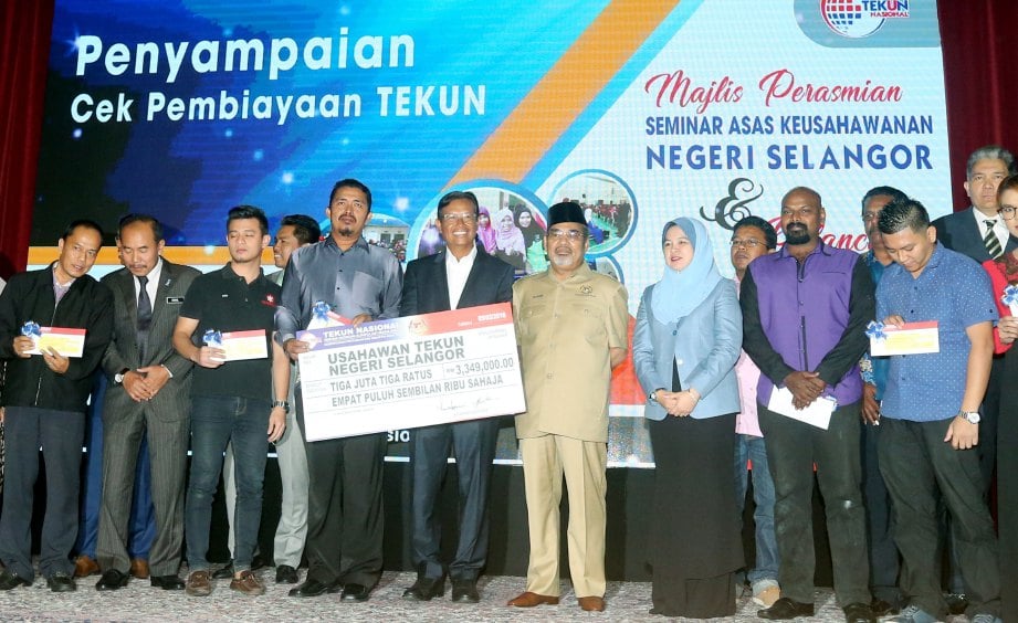 AHMAD Shabery (tengah) bersama penerima bantuan TEKUN ketika majlis perasmian Seminar Asas Keusahawanan Negeri Selangor dan pelancaran aplikasi telefon pintar, TEKUN Pay  di Putrajaya.