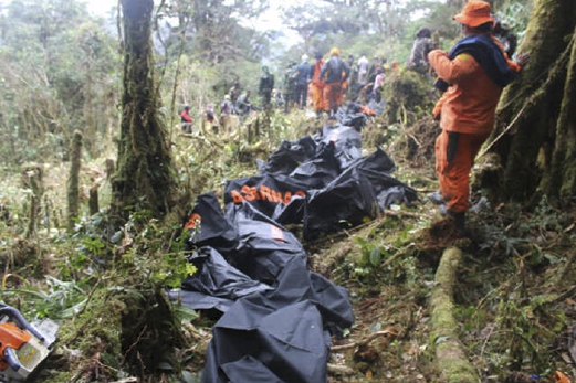 Anggota penyelamat berdiri berdekatan deretan mayat mangsa nahas pesawat ATR 42-300 Trigana Air Service Indonesia yang terhempas di Papua, bersedia untuk dibawa turun menggunakan jalan darat. - Foto Reuters
